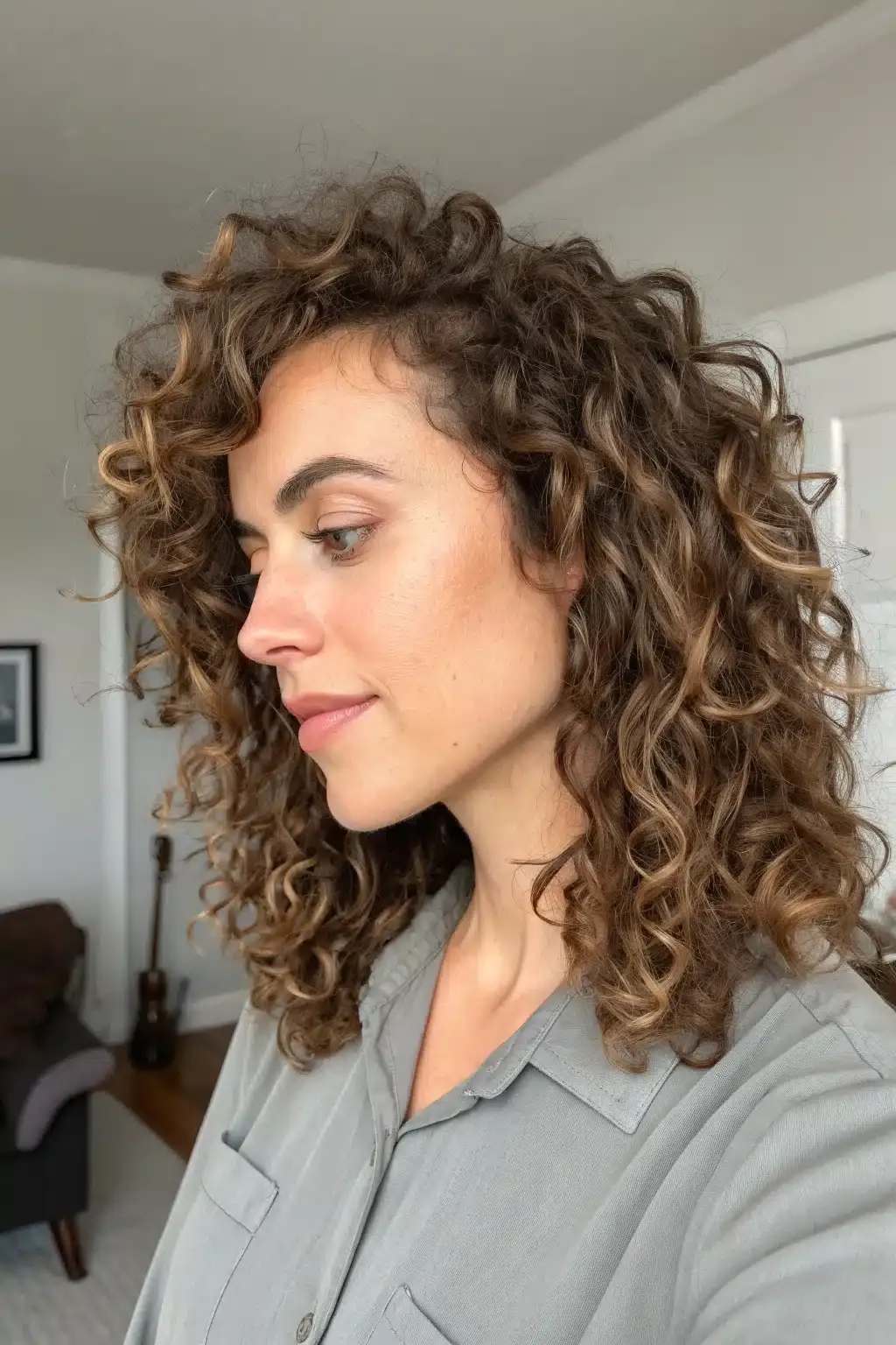 7) Curly Side Bangs with Natural Texture