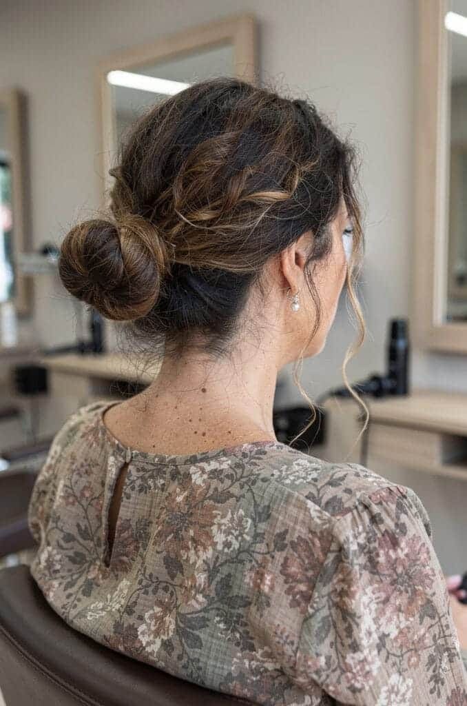 Low Messy Bun with Face Framing Curls