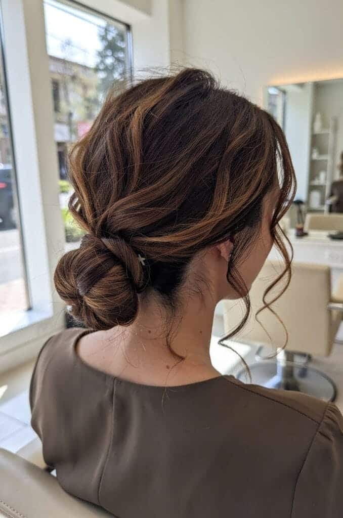 Low Messy Bun With Face-Framing Pieces