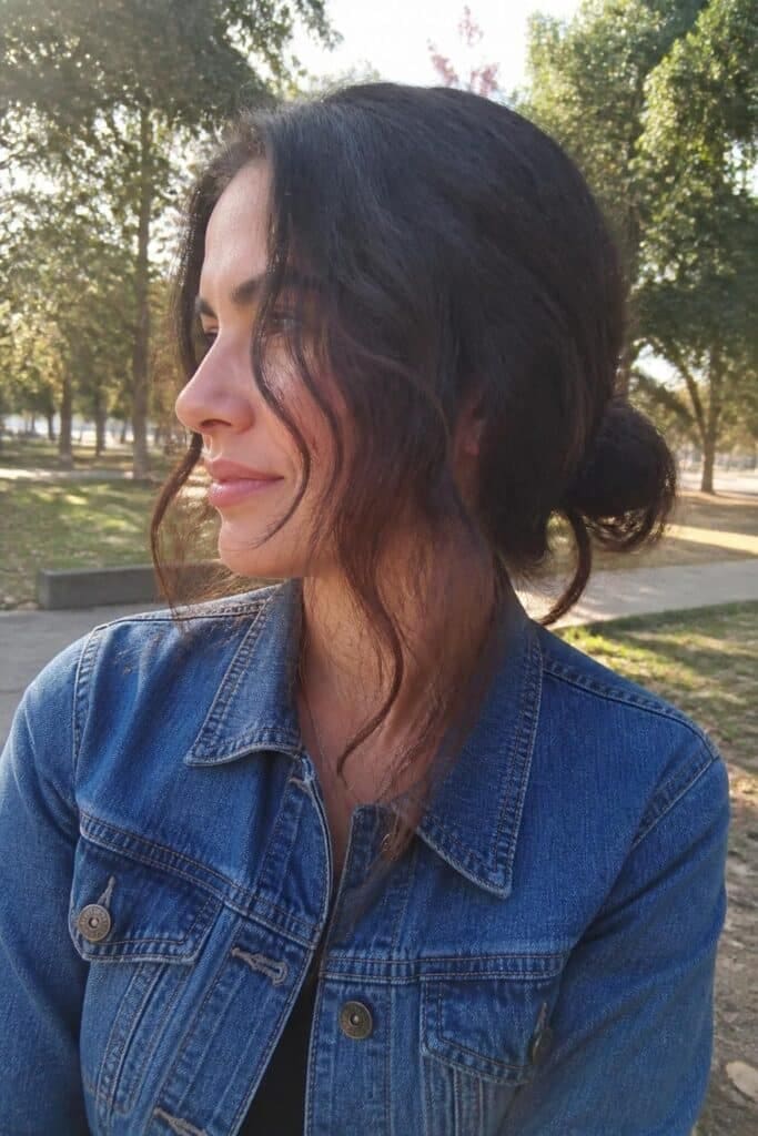 3. Messy Low Bun with Wavy Pieces