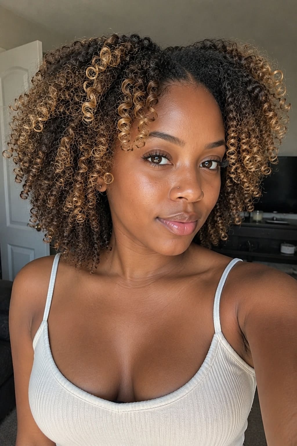 8. Soft Blonde Highlights on Natural Curls