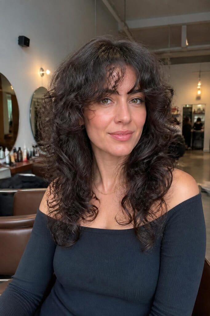 13. Butterfly Cut with Curly Fringe