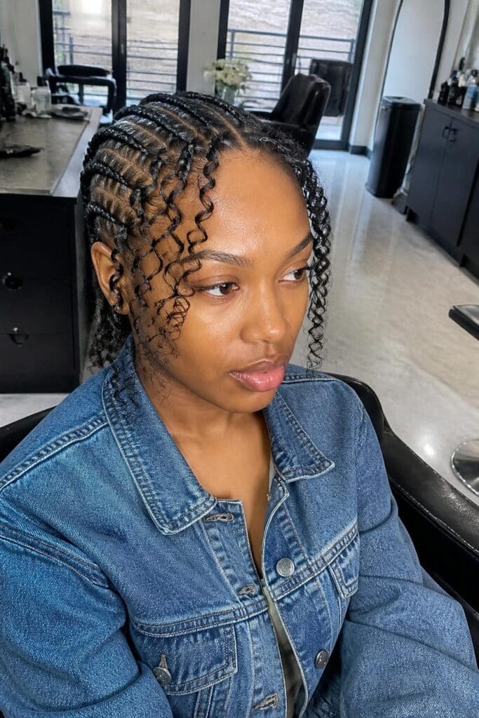4. Cornrows with Curly Bangs